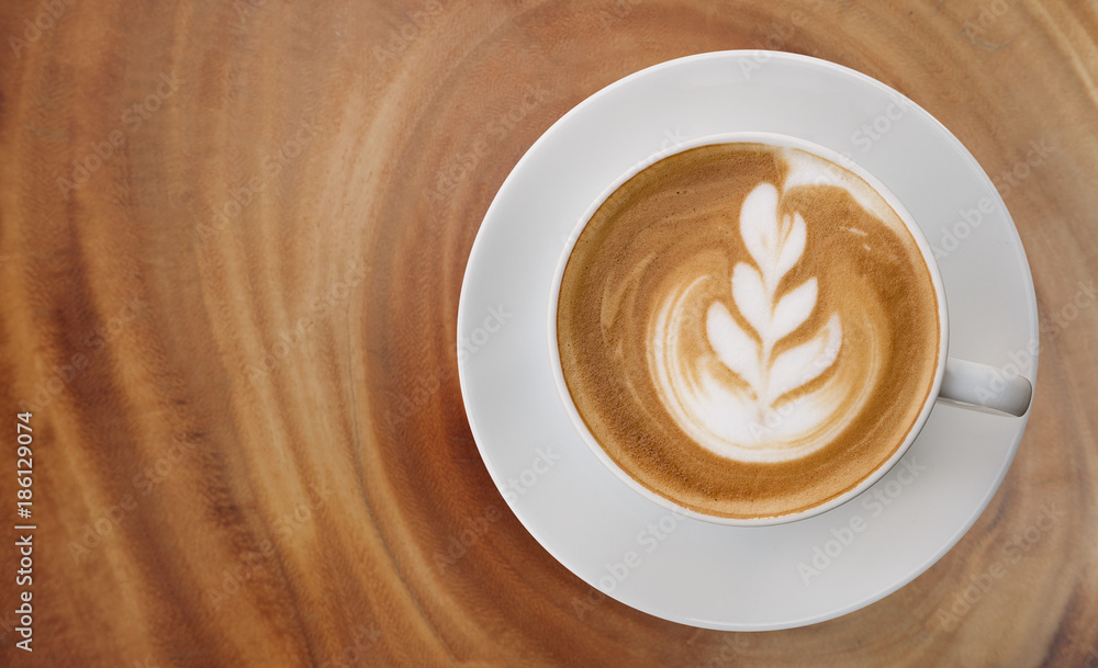 Wall mural hot coffee cappuccino latte art top view on wooden background