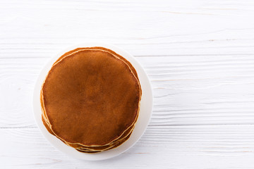 Pancakes on a wooden table. Place for text or design.