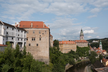 Fototapeta na wymiar View of the charming medieval town, Cesky Krumlov, from the castle. Renaissance Castle Tower and the Church of St Jost (Kostel sv Josta) in the background. Vltava River down below flowing through town