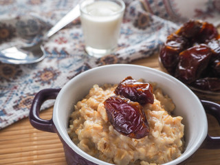 Healthy eating, healthy breakfast food. Oatmeal porridge with dates and milk. 