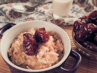 Healthy eating, healthy breakfast food. Oatmeal porridge with dates and milk. 
