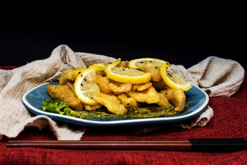 Chinese food fried fish and lemon slices
