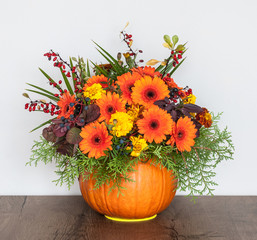 Autumn bouquet in a vase made out of pumpkin