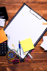 Stationery and calculator on wooden background. Office supplies concept.