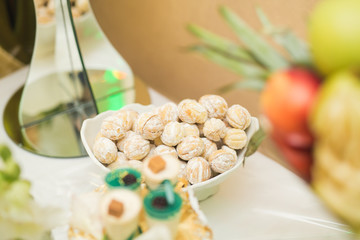 Delicious and tasty dessert table with cupcakes shots at reception closeup