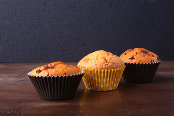 Tasty chocolate cupcakes, muffins on a white wooden table