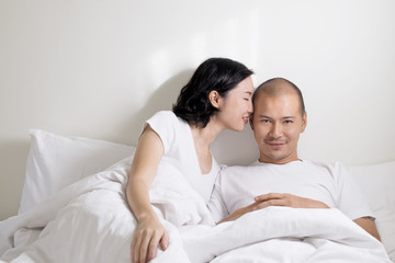 Couple on white bed. Happiness time for lover.