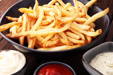 Red and white french fries chips with ketchup and mayonnaise