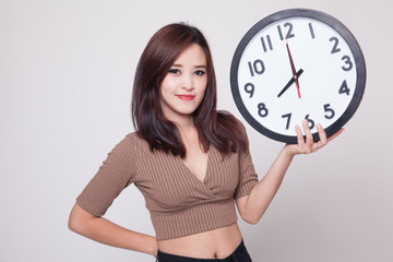 Young Asian woman with a clock.