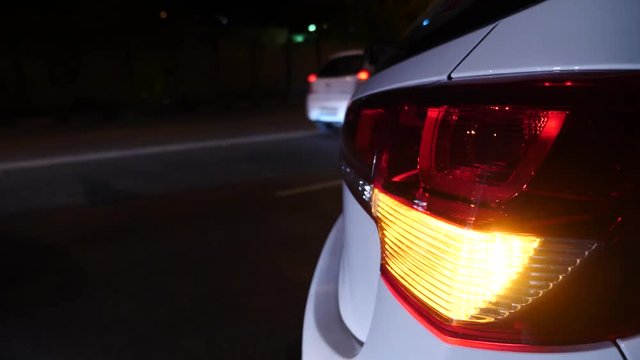 night. car blinker light. emergency car warning light on the background of moving cars on a night road. 4k.