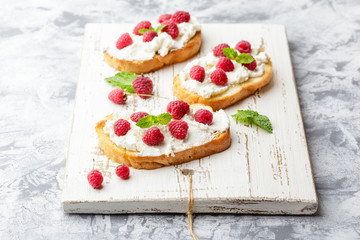 Breakfast slice of bread with Ricotta cheese served with raspberries