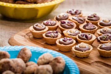 Chocolate Puddings Within Sweet Cookie Bowls on a Wooden Tray