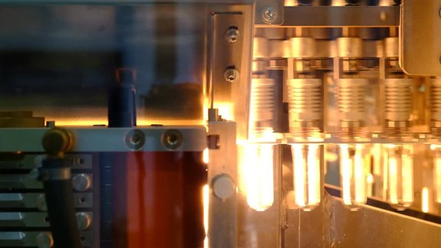 PET bottle preforms. The operation of PET bottle or plastic bottle blowing machine with lighting effect.