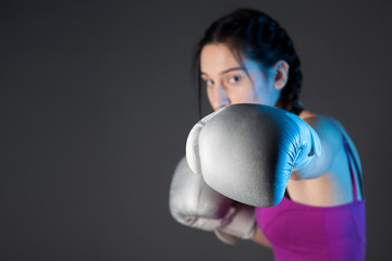 girl with the silver boxing gloves, black background with copy space