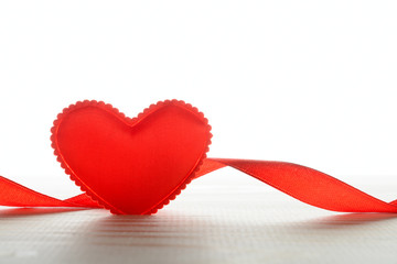 Small fabric heart and ribbon on table