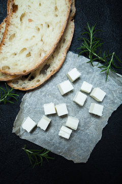 Healthy diet food - feta cheese on a black background.