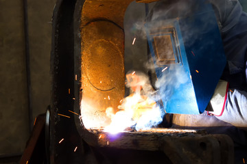 Worker welder in the metal industry