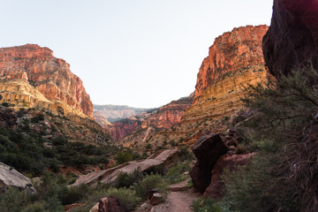 Landscape view in the Grand Canyon, Arizona with a waterfall, river, and valley walls. 