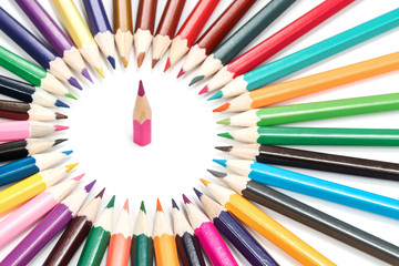 Small sharpened pencil looking up in a circle from a set of pencils lying one near the other,...