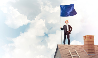 Young businessman with flag presenting concept of leadership. Mi