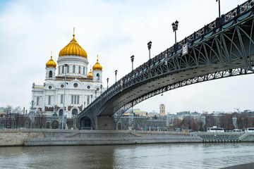 Fototapeta na wymiar Cathedral Of Christ Savior With Bridge In Winter Day. Famous Christian Landmark In Russia. Moscow, Russia.