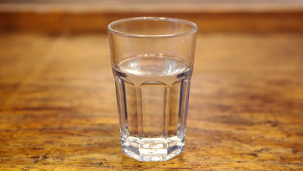 glass with water on rustic wooden table