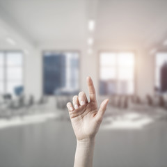 Choosing gesture of person in elegant modern interior in sunshin