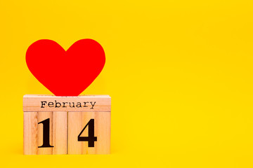 Happy Valentines Day card with red paper heart and wooden calendar on yellow background