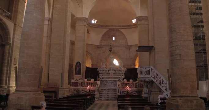 ALGHERO, SARDINIA, ITALY  &ndash; JULY 2016 : Video shot of church interior in Alghero with people and altar in view