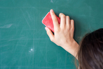 girls hand in elementary school cleaning board with sponge