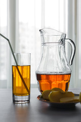 Apple juice in glass and jug on the table