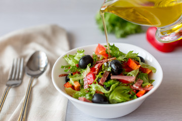 Vegetarian salad, from vegetables, with ham, and olive oil