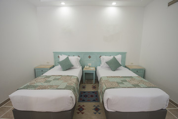 Fototapeta na wymiar Twin beds in a luxury suite of a hotel room