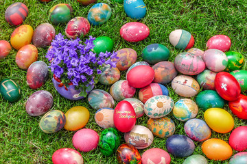 Colorful Easter Eggs on Grass.One of the eggs is written in Bulgarian - He is Risen