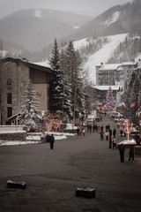 Landscape view of the streets of Vail, Colorado with the ski resort in the background during the winter.  - obrazy, fototapety, plakaty