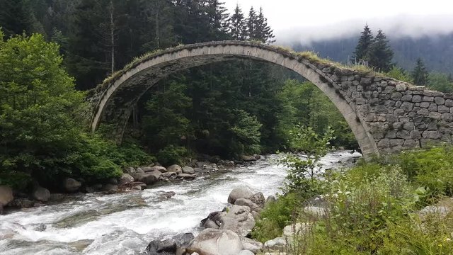 Camlihemsin, Rize, Turkey - July 2017: Historical Ottoman bridge Taskopru in Senyuva, Cinciva in Armenian, over the Firtina river near Camlihemsin in Rize province at the eastern end of Turkey
