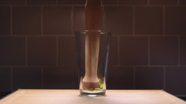 muddling mint in slow motion