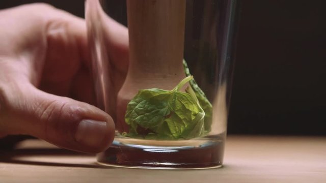 muddling mint in slow motion