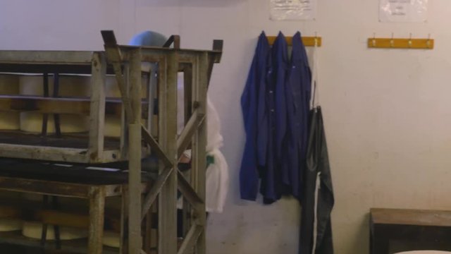 Cheese factory employees prepare cheese for transport to storage
