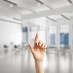 Choosing gesture of person in elegant modern interior in sunshine light