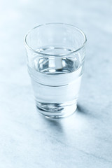 A glass of cold water on gray background