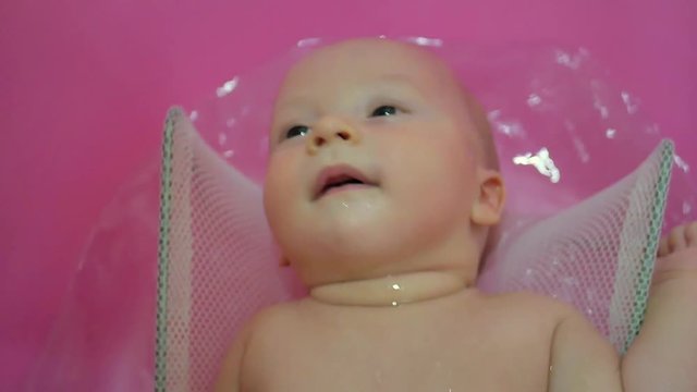 Bath for babies, baby wash your hair. Happy boy taking a bath.