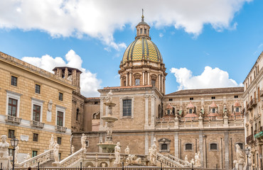 Fototapeta na wymiar View of San Giuseppe dei Teatini church dome with statues of the Pretoria fountain ahead in Palermo, Sicily, Italy