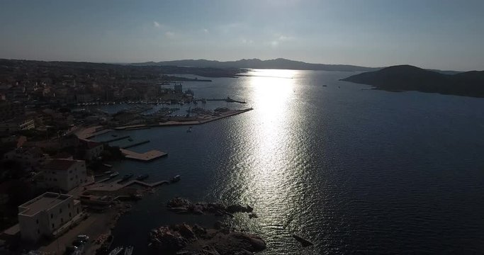 SARDINIA, ITALY  – JULY 2016 : Aerial shot of La Maddalena cityscape on a sunny day with harbour and amazing landscape in view