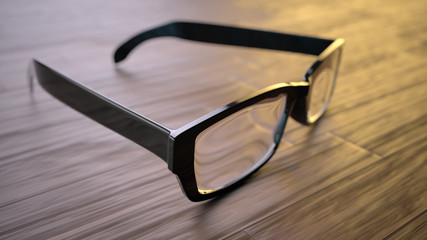 Schwarze Brille liegt auf Holz