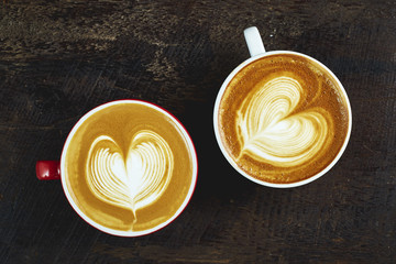 Two cups of coffee on wooden