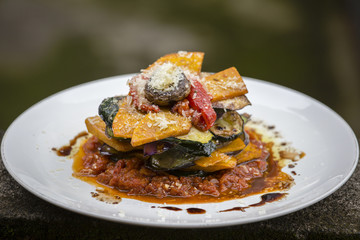Vegetable stack - pumpkin, zucchini, red capsicum, eggplant and mushroom cooked in a tomato, onion, and garlic sauce topped with parmesan cheese