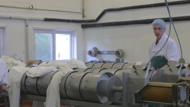 Cheese factory employees go about their work
