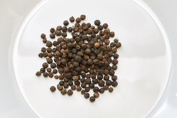 black peppers on white background