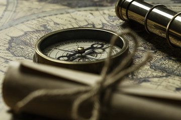 Retro compass with old map and spyglass